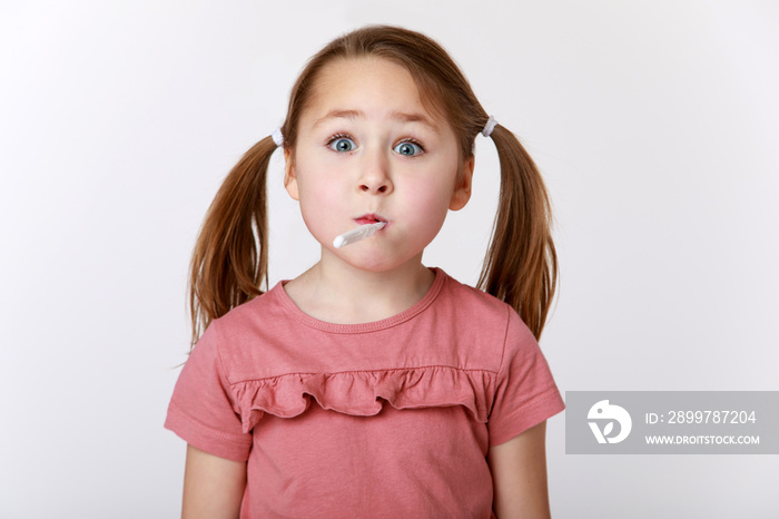 Funny girl with a toothbrush in her mouth