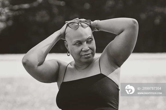 Black and white picture of Bald Black woman outside