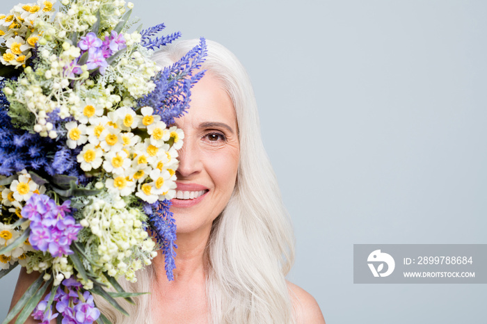 Beautiful retired woman beaming smile hide half face big bunch wild flowers nice smell isolated grey