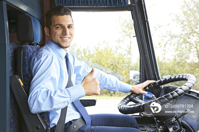 Handsome driver sitting in bus