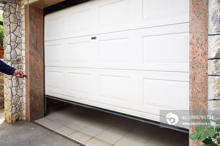 Garage door PVC. Hand use remote controller for closing and opening garage door