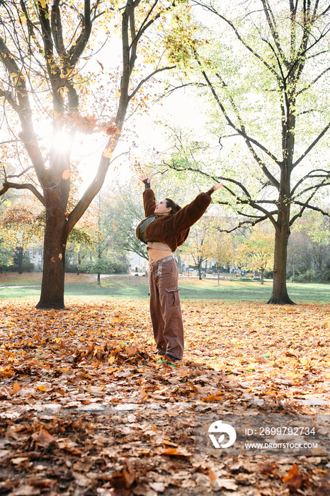 Woman throwing leaves in the air