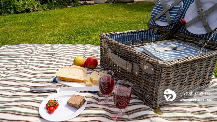 Summers day picnic set on the lawn with food and drink