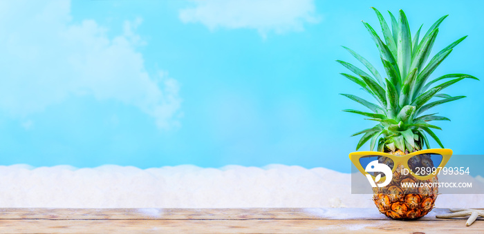 Pineapple with sunglasses on wood background. Creative minimal summer holiday concept