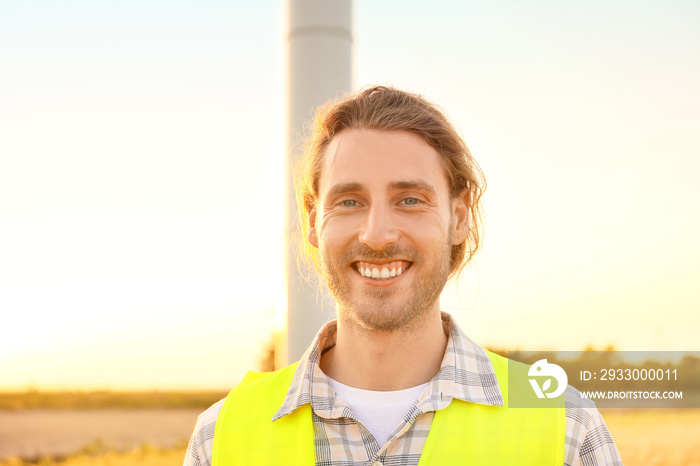 Male engineer on windmill farm for electric power production