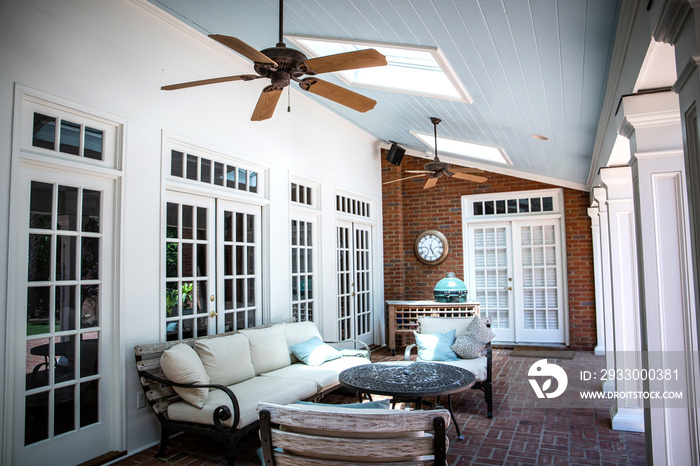 Outdoor Residential Back Patio Porch with Couches and Chairsand a Table