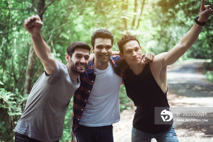 Happy man traveler friends hugging with hands raise up together at nature,Enjoying backpacking concept