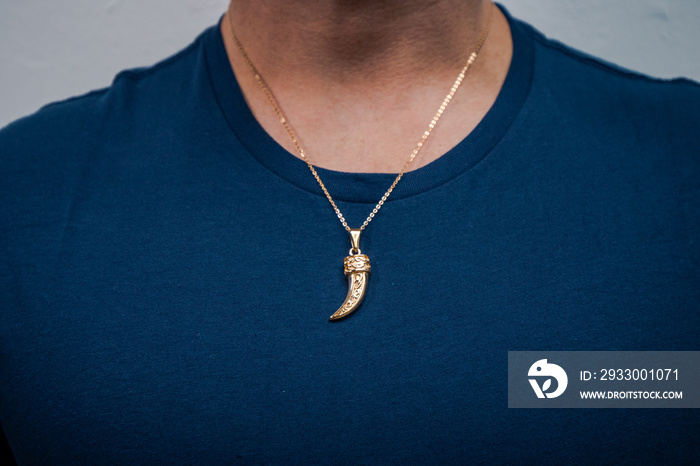 Gold necklace on blue background jewelry fashion