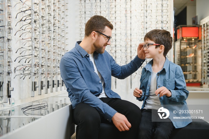 Family buy glasses. Father in a blue shirt