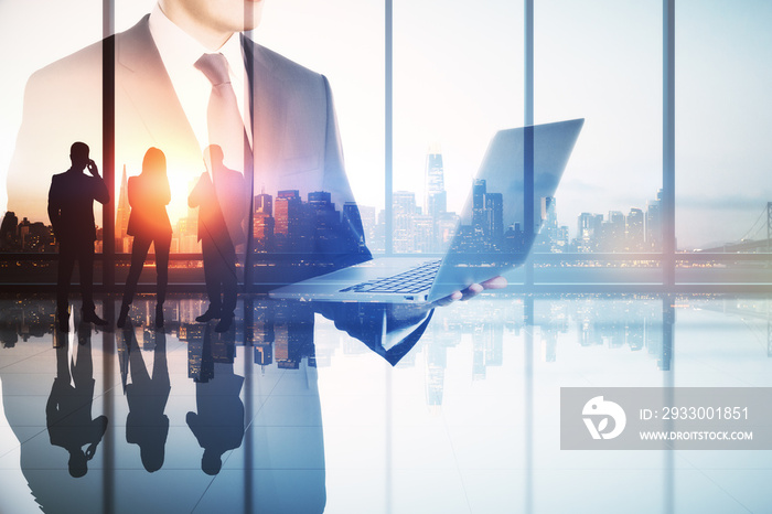 Abstract image of businessman using laptop in modern office interior with panoramic city view, businesspeople and mock up place. Teamwork, leadership and technology concept. Double exposure.