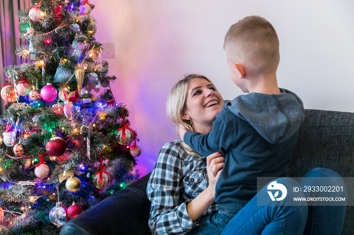 Happy mother and son playing on the sofa