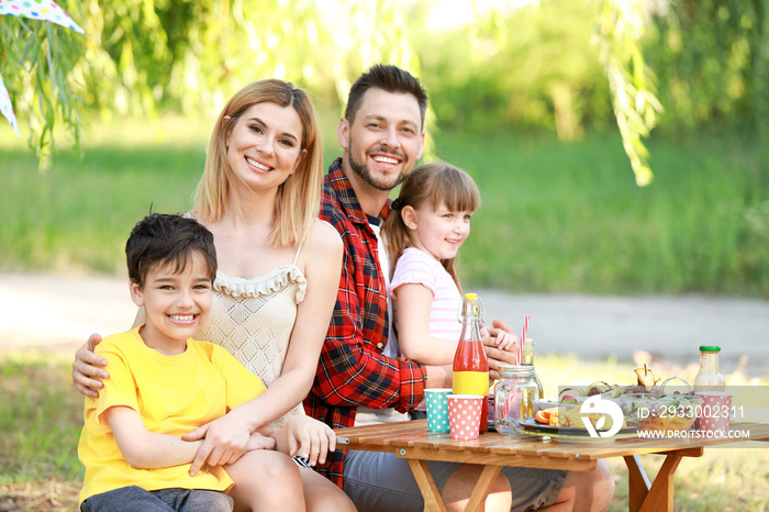 Happy family having picnic on summer day