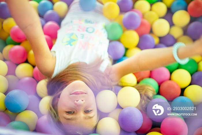 Girl in a T-shirt spends time in the playroom enjoying a summer day