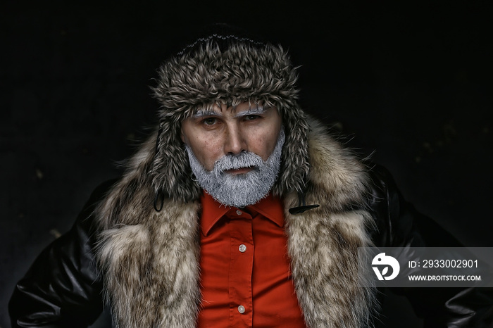 brutal man with a beard in winter clothes / portrait person with a gray beard, hipster warm clothes winter