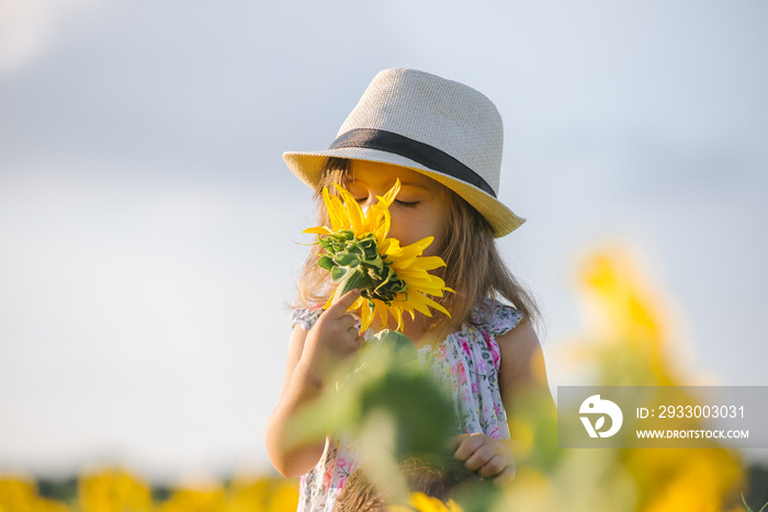 Child and sunflower, summer, nature and fun. Summer holiday.