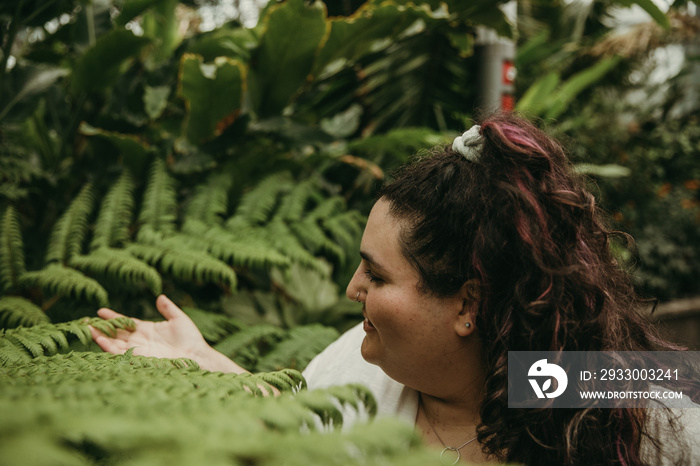 closeup of a plus size woman holding fern