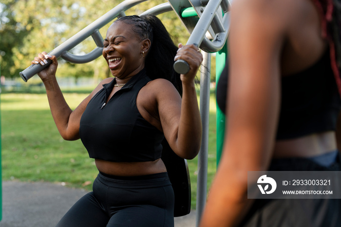 Young women exercising in outdoor gym