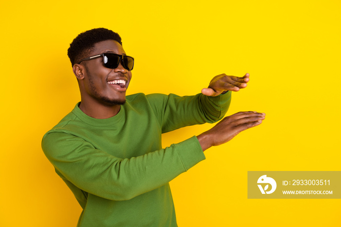 Portrait of attractive cheerful guy dancing having fun night club amusement isolated over bright yellow color background