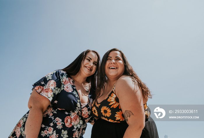 2 plus size metis women laughing and smiling