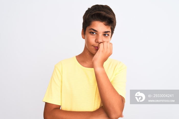 Handsome teenager boy standing over white isolated background looking stressed and nervous with hands on mouth biting nails. Anxiety problem.