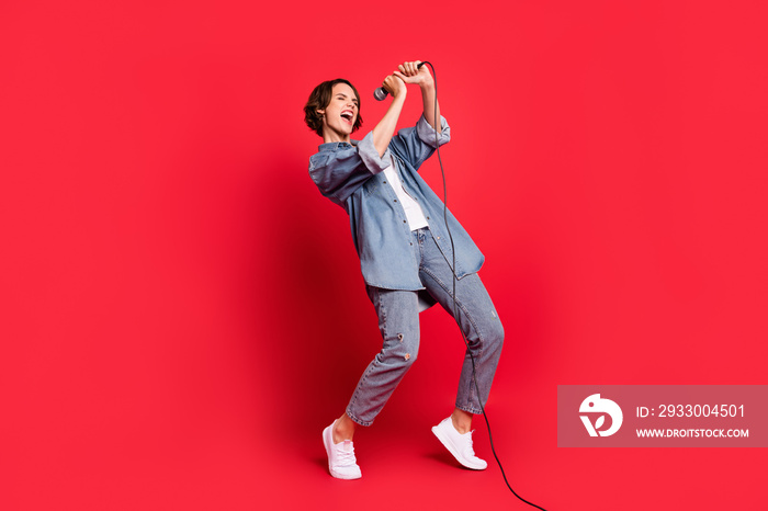 Full body profile side photo of young woman happy positive smile sing microphone music lover isolated over red color background