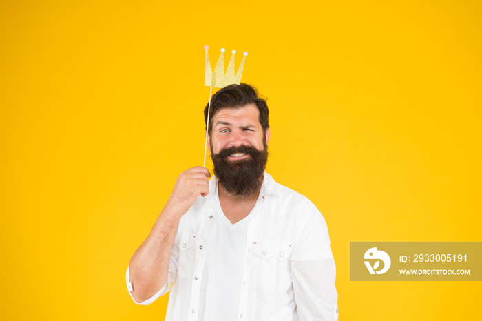 Handsome bearded guy king. Guy in yellow background posing with booth props. Photo booth fun. Bearded man king costume party. King of party. Costume party. Holiday carnival celebration. Birthday boy