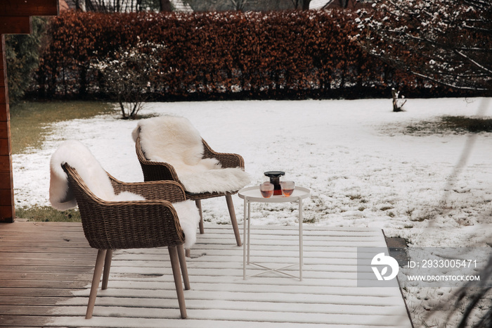 Nice wooden hut in a garden with snow. Garden shed with chairs in winter. Winter mood. Drinking tea outside by cold in winter.  snow in Germany. garden in winter. holiday house