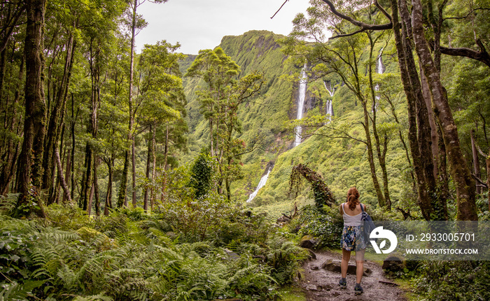 Woman at waterfall, Poco do Ferreiro, Flores island, Portugal, hiking.