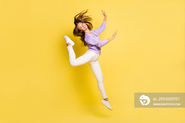 Full length body size view of lovely cheerful girl jumping having fun dancing move ballet isolated over bright yellow color background