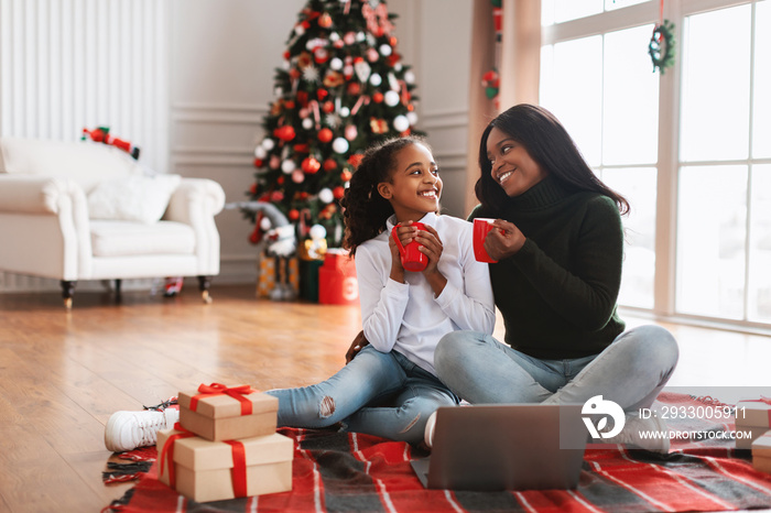 Portrait of happy black women drinking coffee on Xmas eve