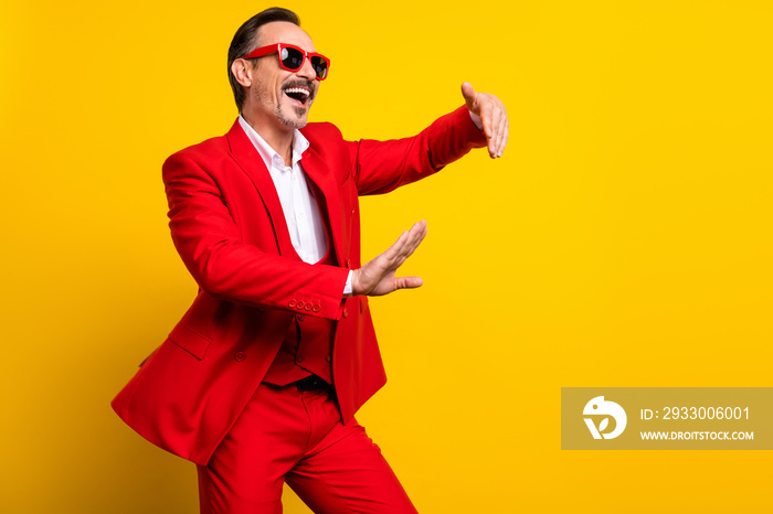 Photo of smiling positive guy dancing fooling around wear well-dressed formalwear suit isolated on yellow color background