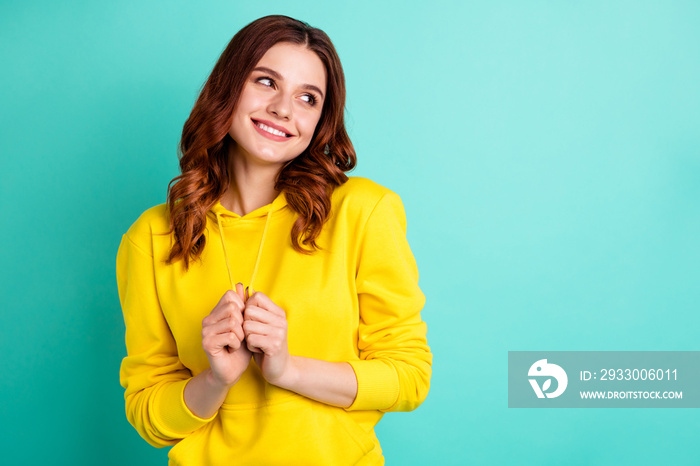 Photo of attractive cute lovely adoring girlish youngster admiring empty space near her isolated over vivid color teal background