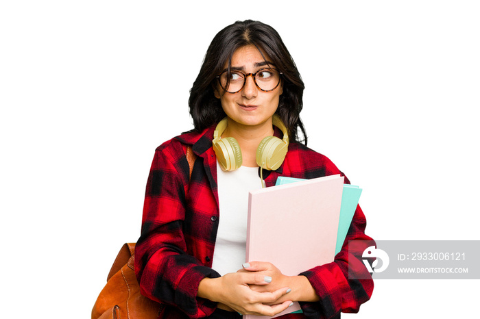 Young student Indian woman wearing headphones isolated confused, feels doubtful and unsure.