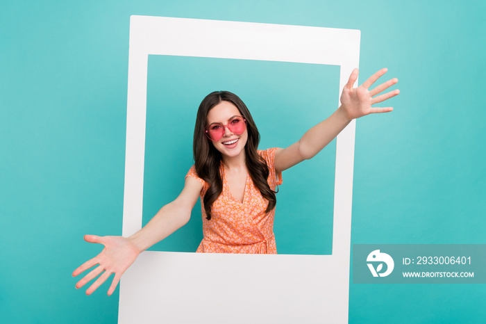 Photo of excited shiny lady dressed orange clothes glasses embracing you taking retro photo isolated teal color background