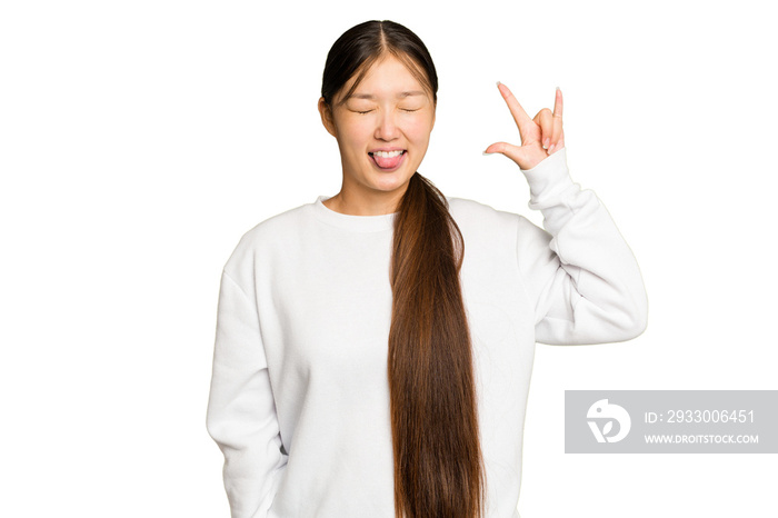 Young Asian woman isolated on green chroma background showing rock gesture with fingers