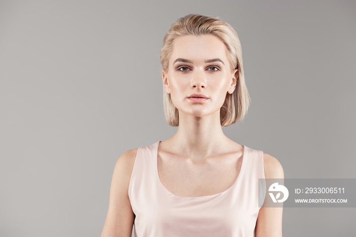 Appealing young lady with bob haircut and grey eyes