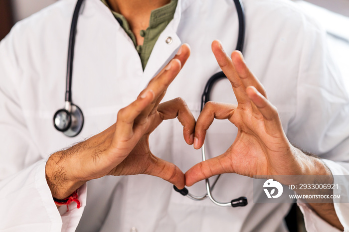 hispanic medical student in white coat with stethoscope in clinic