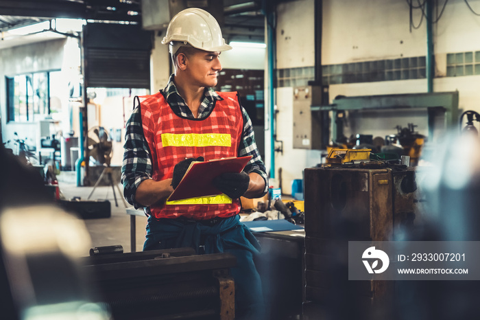 Manufacturing worker working with clipboard to do job procedure checklist . Factory production line occupation quality control concept .