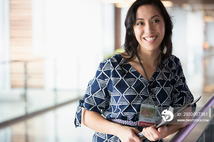 Stylish conference attendee holding handouts.