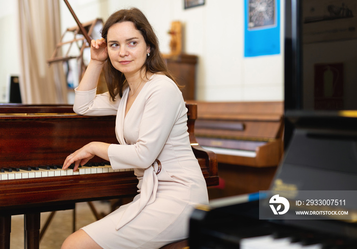 Attractive young woman chooses pianoforte in a record store