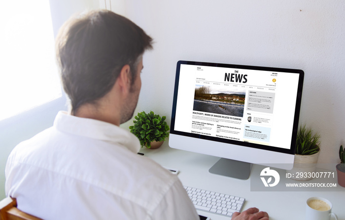 man reading news on the computer