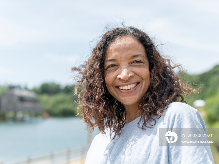 Portrait of smiling woman by lake