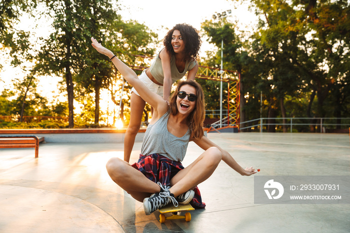 Two positive young girls having fun while riding