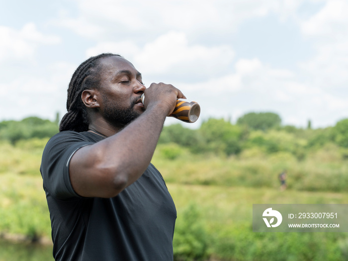 Man drinking protein drink during workout