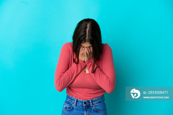 Young caucasian woman isolated on blue background with tired and sick expression