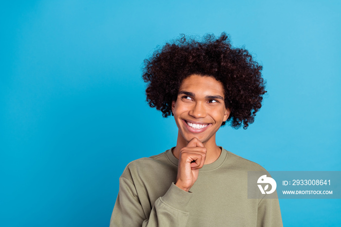 Photo of young cheerful man dream curious look empty space plan creative isolated over blue color background