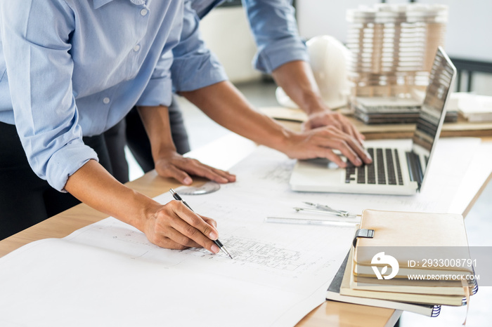 Close-up Of Person’s engineer Hand Drawing Plan On Blue Print with architect equipment, Architects discussing at the table, team work and work flow construction concept