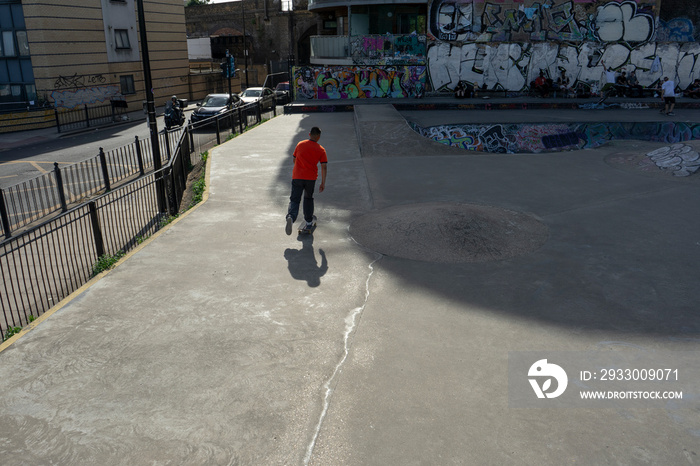 Young man skateboarding in skate park