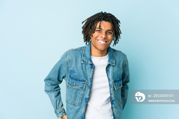 Young black man wearing a jeans jacket happy, smiling and cheerful.