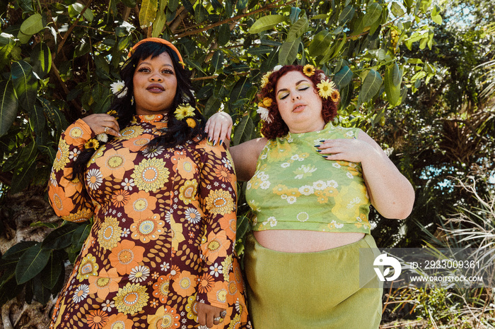 2 plus size friends hang out outside eyes closed